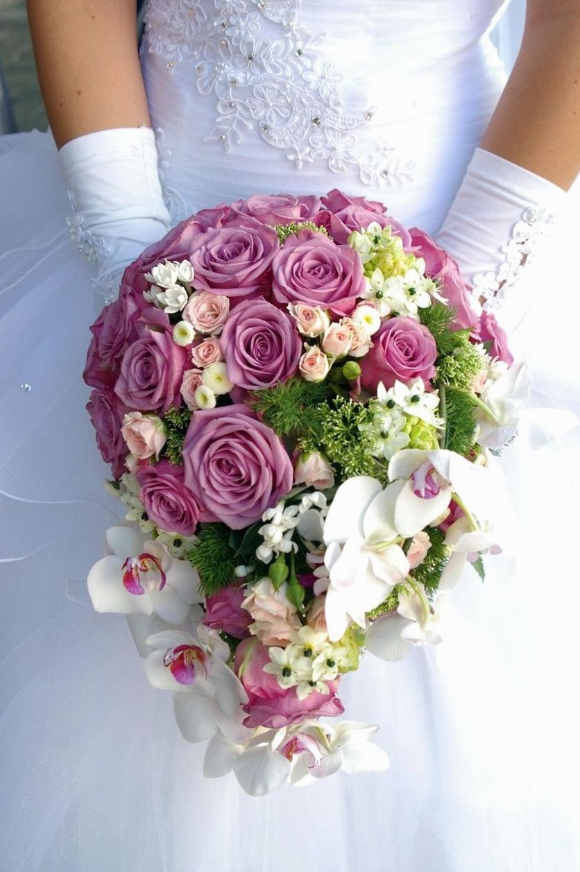 Florist tying a mixed seasonal bouquet on the studio bench